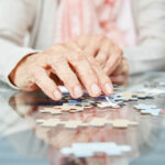 hands of an elderly person with a puzzle